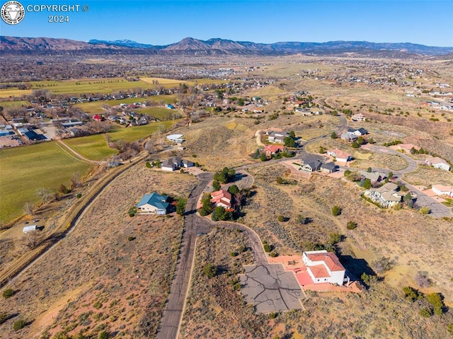 birds eye view of property with a mountain view