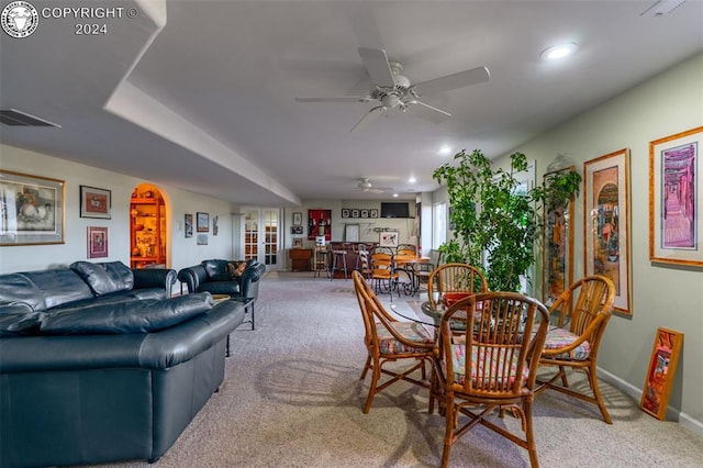 dining space with ceiling fan and carpet flooring