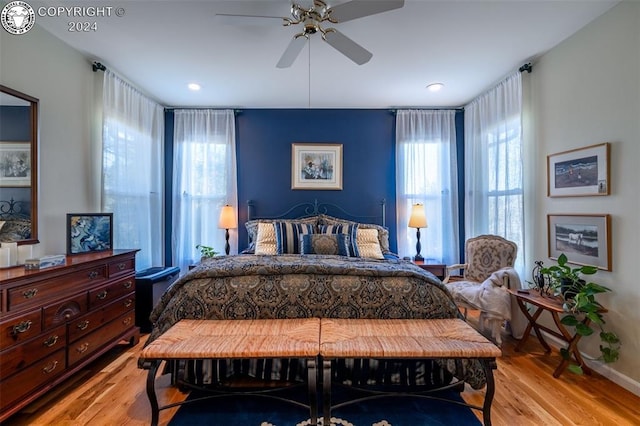 bedroom with ceiling fan and light hardwood / wood-style flooring