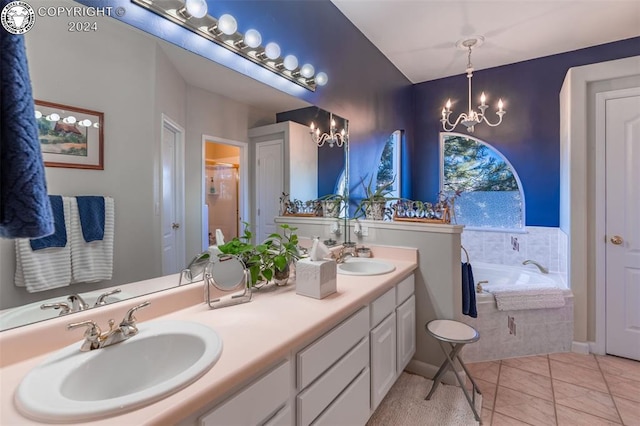 bathroom featuring an inviting chandelier, tiled tub, and vanity