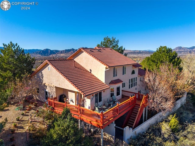 back of house with a deck with mountain view