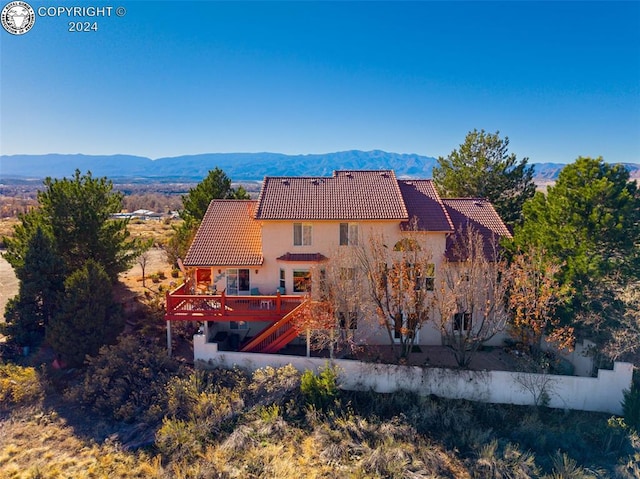 back of house with a deck with mountain view