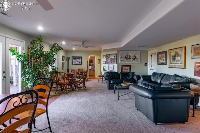 carpeted living room with ceiling fan