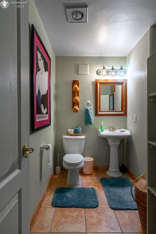 bathroom with tile patterned flooring and toilet