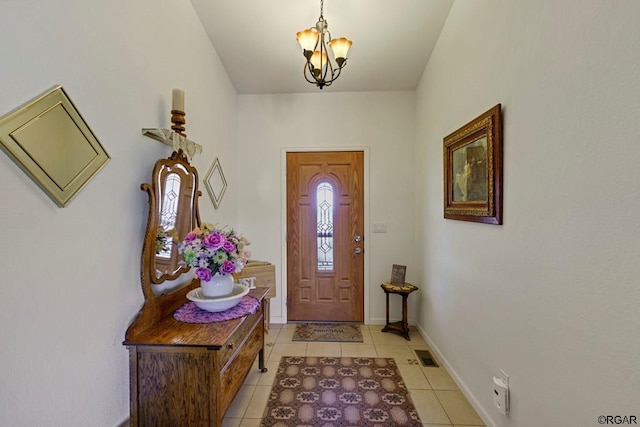 entrance foyer featuring an inviting chandelier and light tile patterned floors