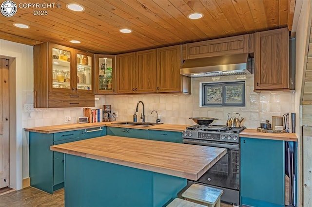 kitchen featuring stainless steel range with gas cooktop, wall chimney range hood, butcher block countertops, decorative backsplash, and a sink