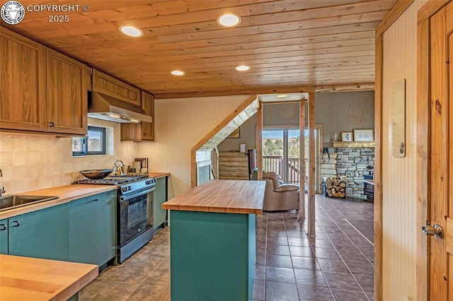 kitchen featuring a wealth of natural light, black range with gas cooktop, butcher block counters, wall chimney range hood, and wood ceiling