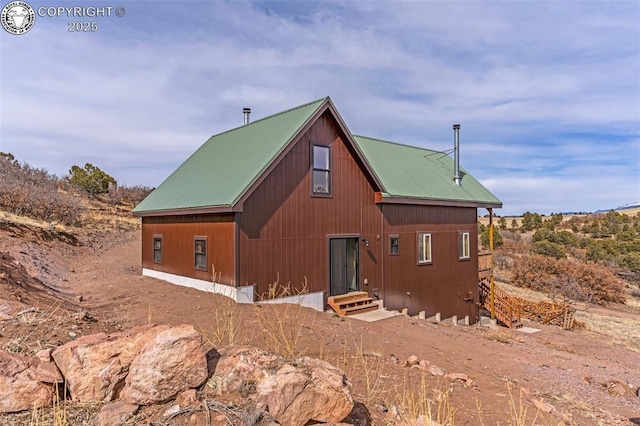 back of property featuring metal roof