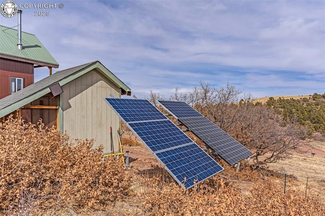 view of side of property with solar panels