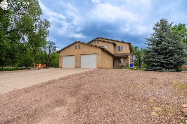1002 Ussie Ave, Canon City, CO 81212 - traditional home featuring concrete driveway, an attached garage, and stucco siding