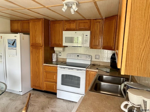 kitchen with sink and white appliances