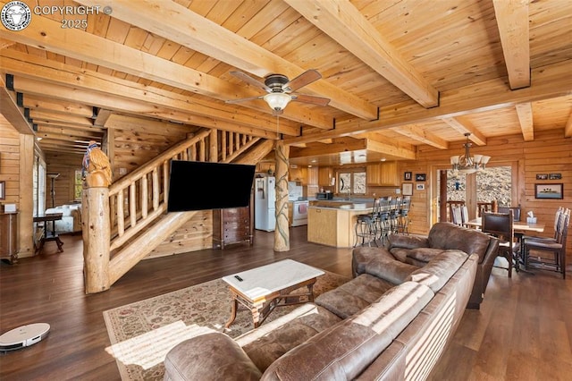 living room with beam ceiling, dark hardwood / wood-style flooring, wood ceiling, and wooden walls