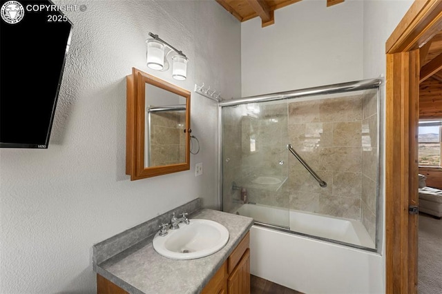 bathroom with vanity and shower / bath combination with glass door