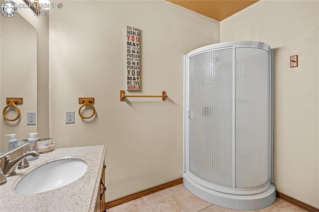 bathroom featuring vanity, tile patterned floors, and walk in shower