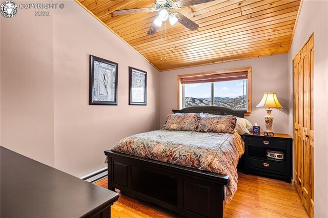 bedroom with a baseboard radiator, lofted ceiling, wooden ceiling, and light hardwood / wood-style flooring