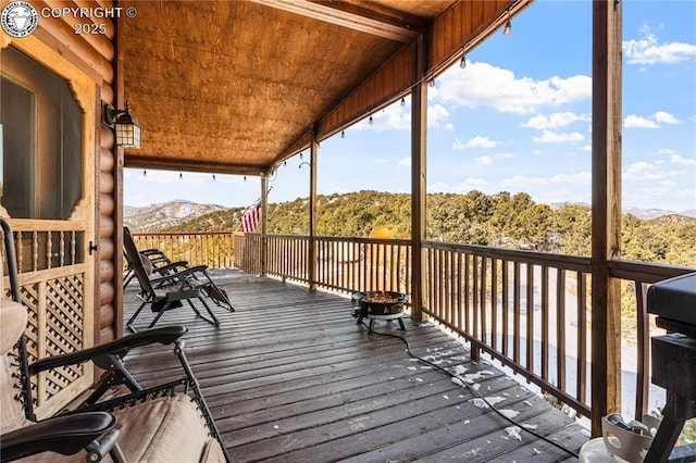 wooden deck featuring a mountain view