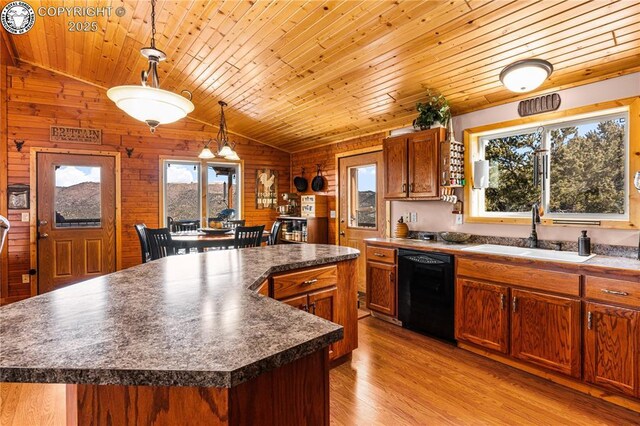 kitchen with pendant lighting, sink, dishwasher, plenty of natural light, and a kitchen island