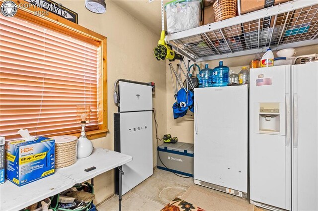 kitchen with white refrigerator with ice dispenser and white refrigerator