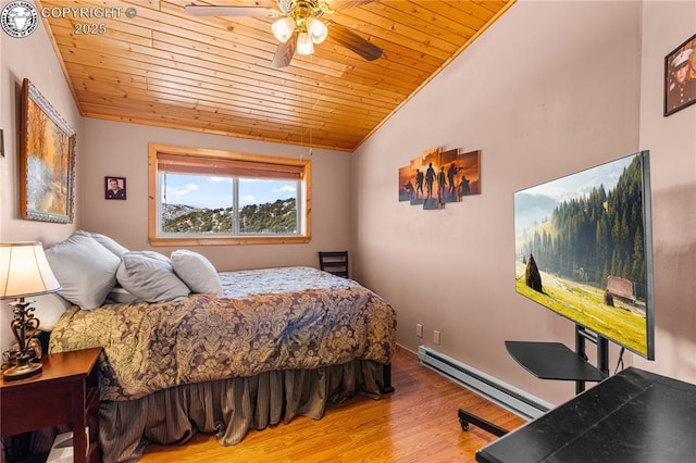 bedroom with a baseboard heating unit, vaulted ceiling, wooden ceiling, and hardwood / wood-style floors