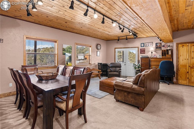 dining area with french doors, track lighting, and wooden ceiling