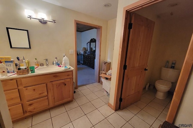 bathroom featuring tile patterned flooring, vanity, and toilet