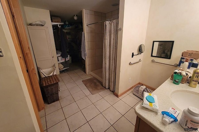 bathroom with walk in shower, tile patterned floors, and vanity