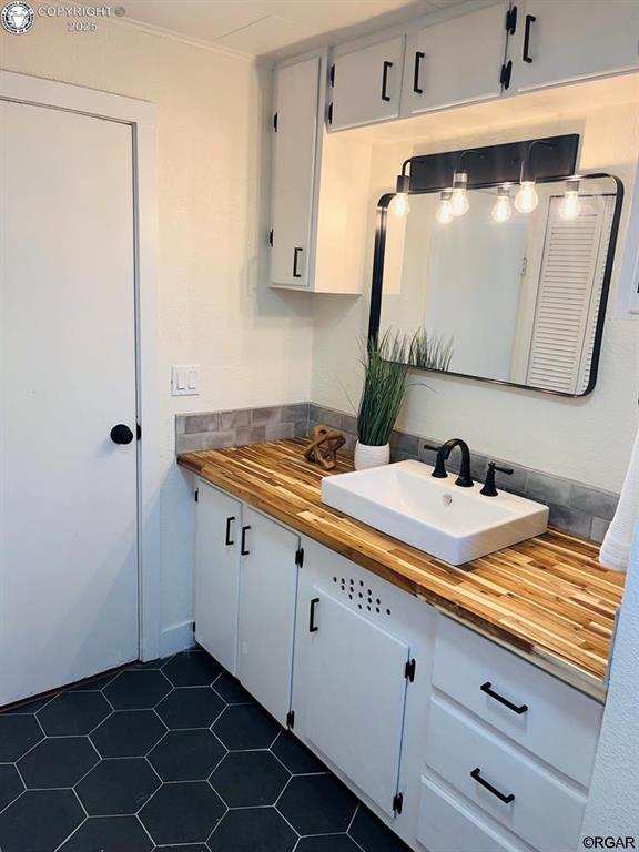 bathroom with vanity and tile patterned floors