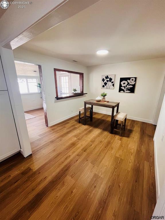 dining room with baseboards and wood finished floors