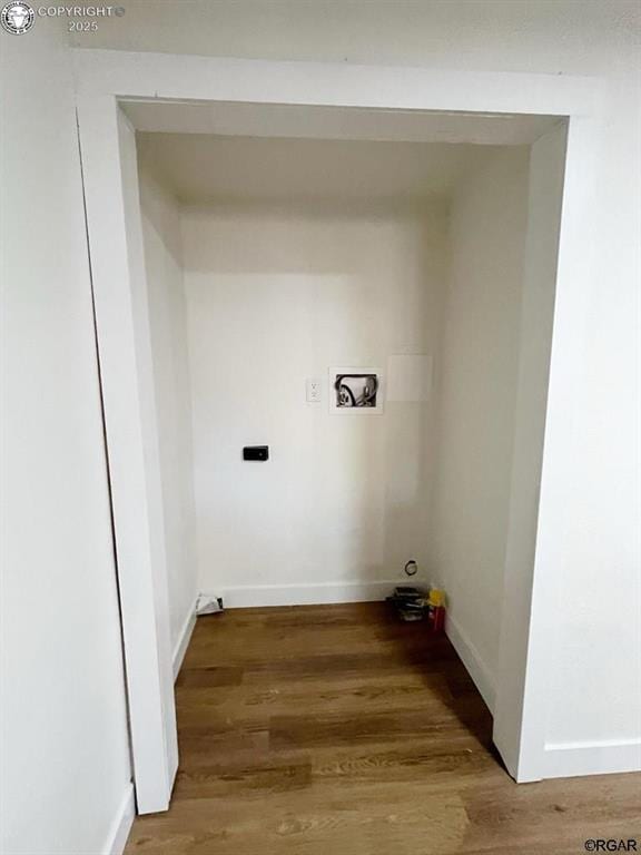 laundry room with laundry area, light wood-type flooring, and baseboards