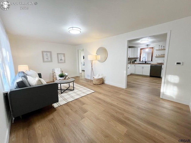 living area with light wood finished floors and baseboards