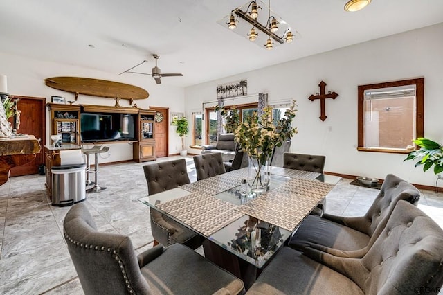 dining room with ceiling fan with notable chandelier