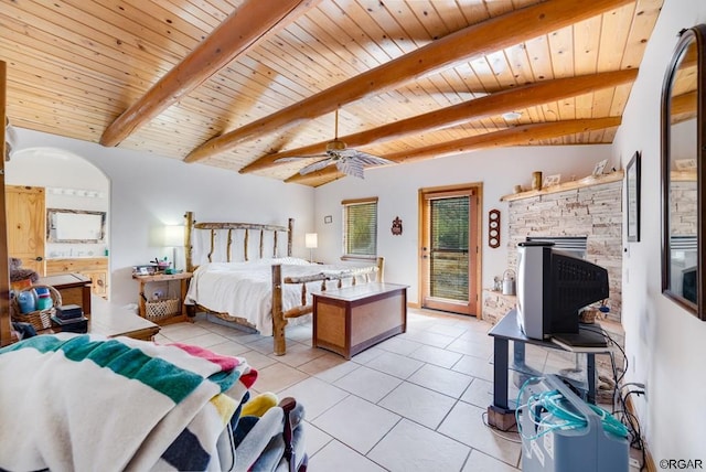 bedroom with beamed ceiling, light tile patterned floors, and wooden ceiling