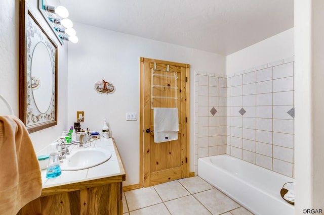 bathroom featuring vanity, tile patterned floors, and tiled shower / bath