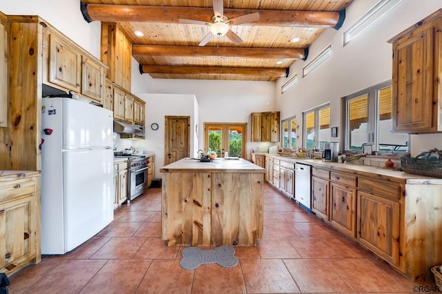 kitchen with wood ceiling, a kitchen island, a towering ceiling, stainless steel appliances, and beam ceiling