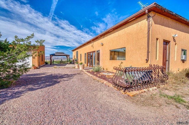 view of property exterior featuring a gazebo