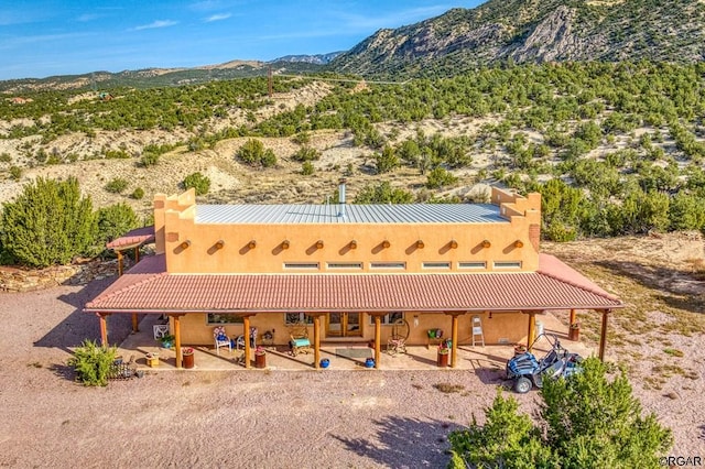 exterior space with a mountain view and a patio area