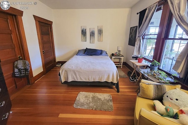 bedroom with dark wood-type flooring