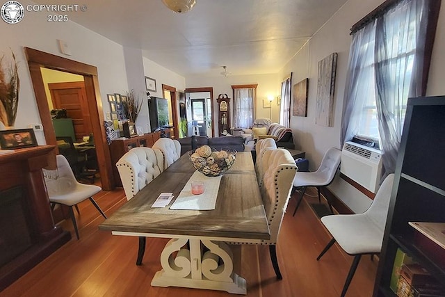 dining room with cooling unit and light wood-type flooring