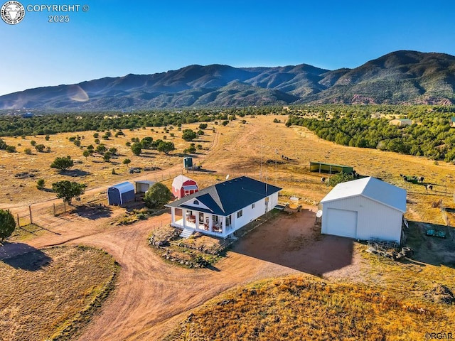 birds eye view of property with a rural view and a mountain view