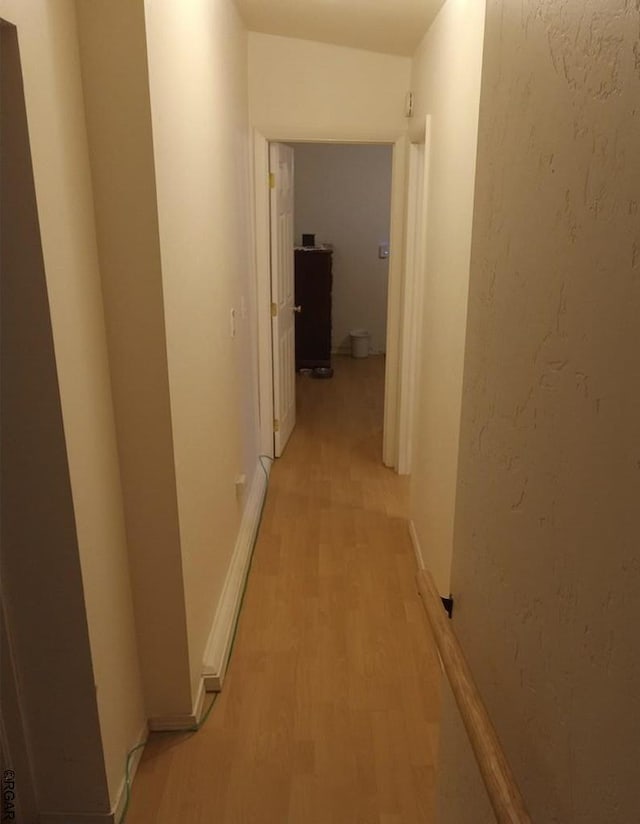 hallway with light hardwood / wood-style flooring