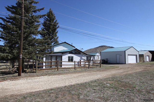 view of front of property featuring a garage and an outdoor structure