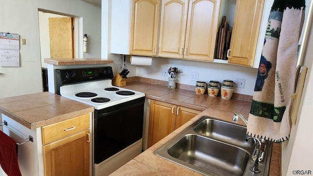 kitchen featuring electric range oven, tile counters, sink, and light brown cabinets