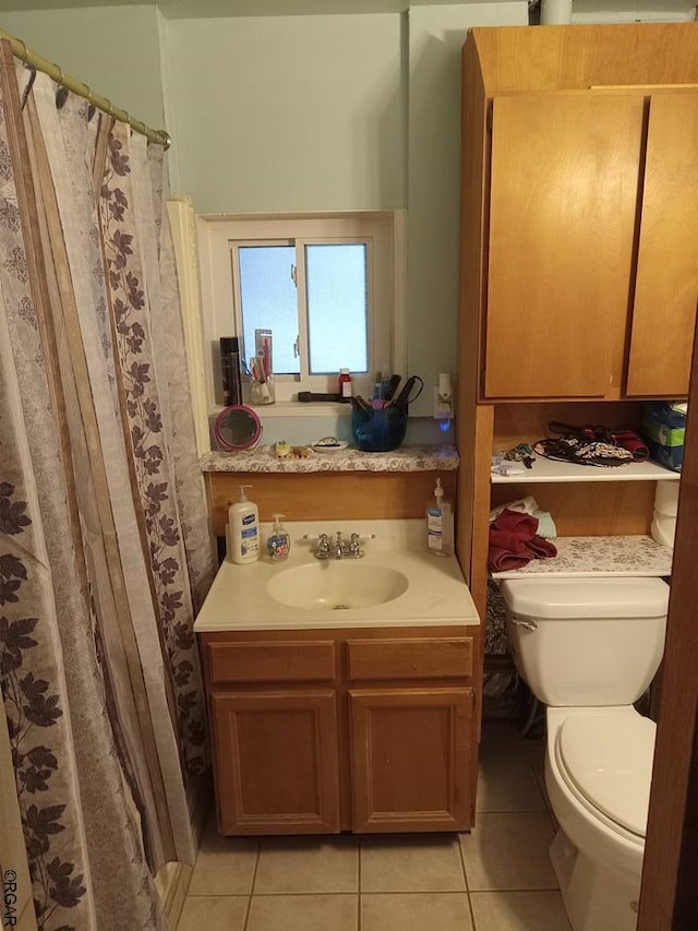 bathroom featuring tile patterned floors, toilet, and vanity