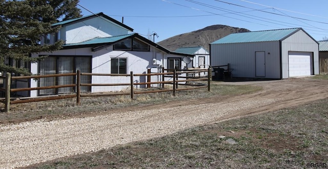 exterior space featuring a mountain view, an outbuilding, and a garage