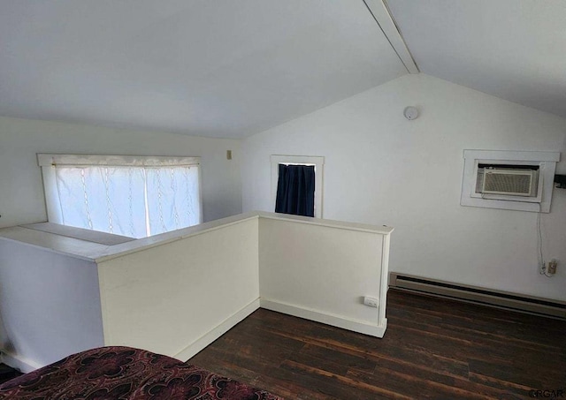 interior space featuring dark wood-type flooring, a wall mounted air conditioner, vaulted ceiling, and a baseboard heating unit