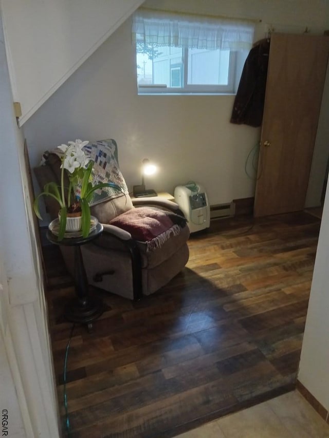 living area with hardwood / wood-style floors and baseboard heating