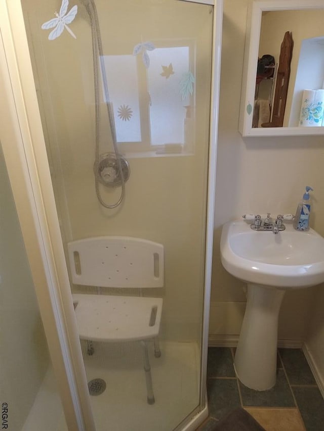 bathroom with tile patterned floors and a shower