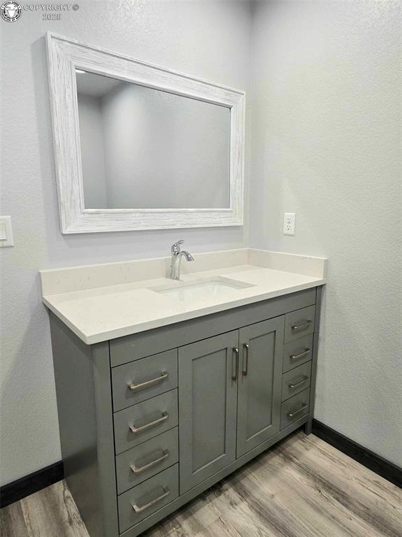 bathroom featuring vanity and wood-type flooring