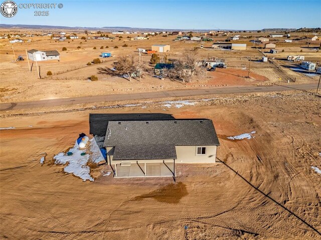 birds eye view of property with a rural view