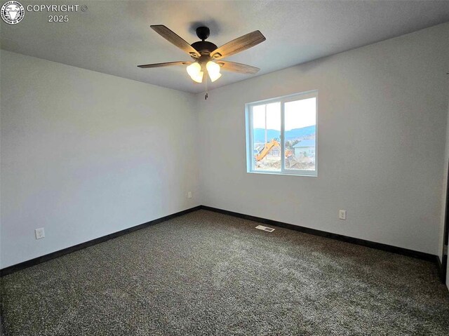 empty room with ceiling fan and carpet